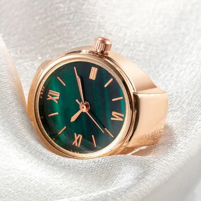 gold and green punk finger watch displayed on side