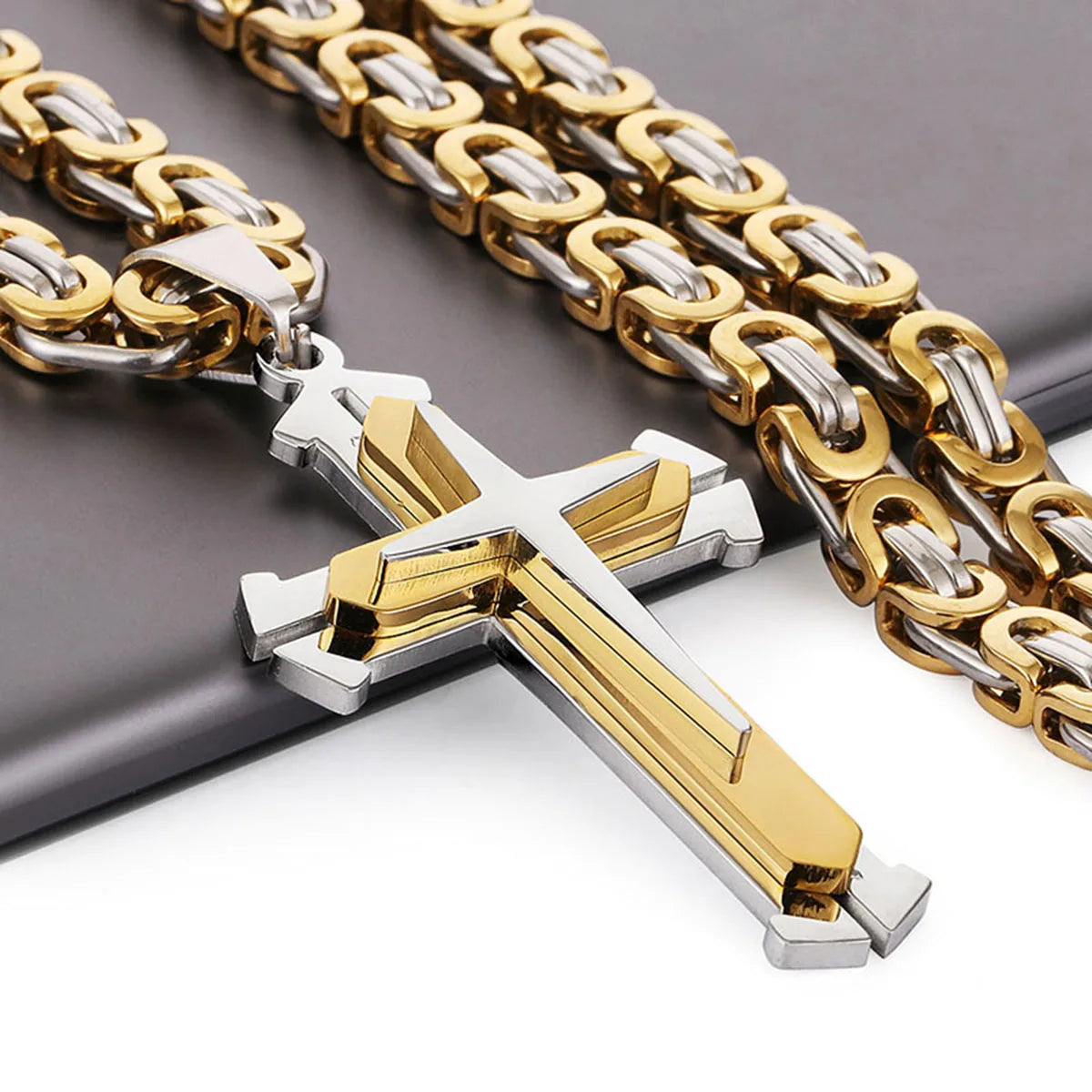 close up of silver and gold cross and chain