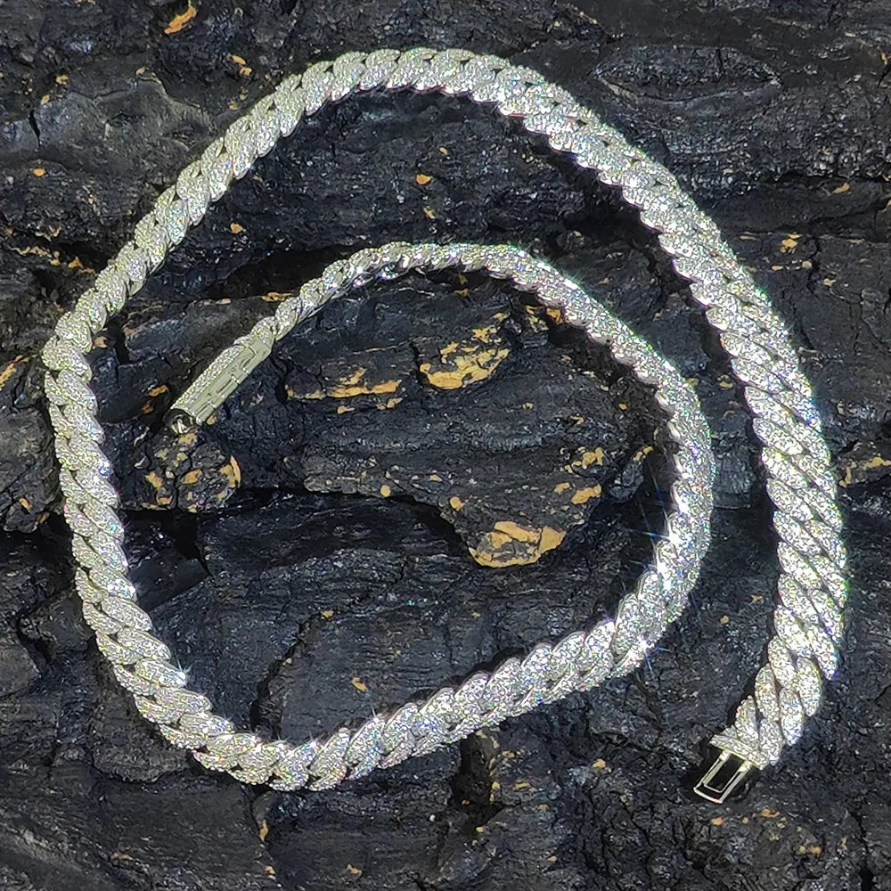 Gold Iced out Cuban chain laid in circle on rock