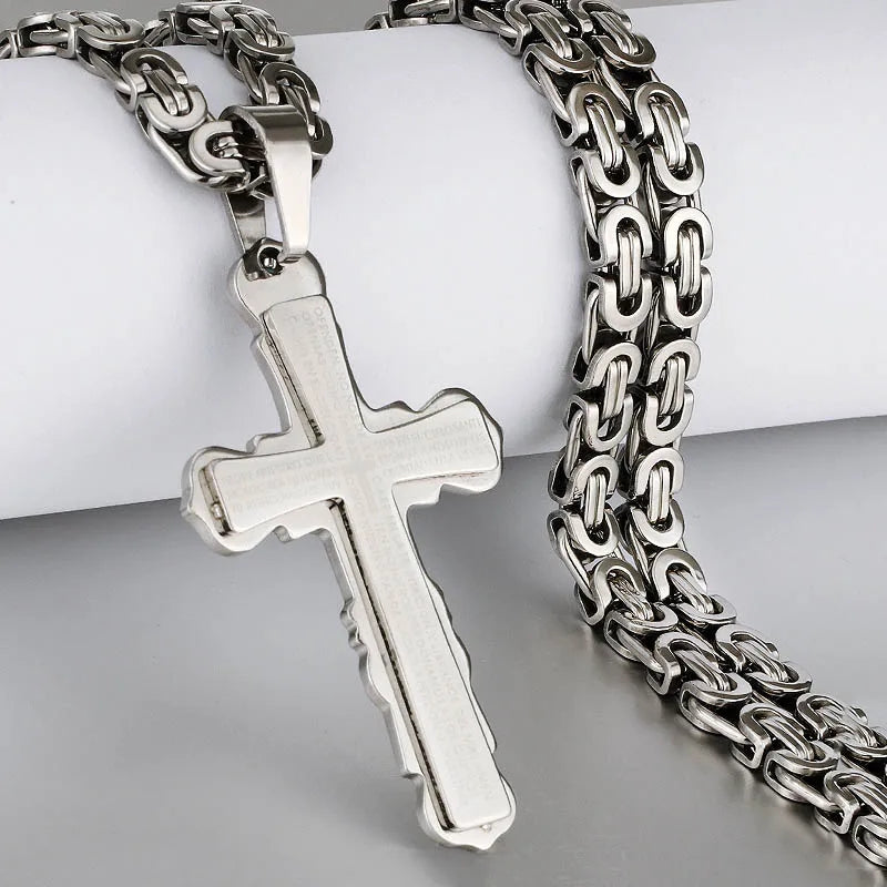 all silver cross and chain displayed with jewelry holder