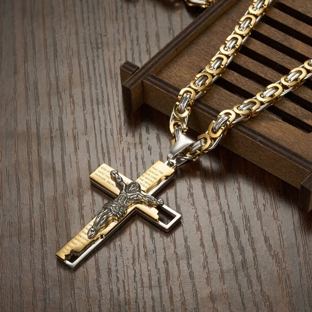 Silver and gold Byzantine cross and chain laying on table diagonally 