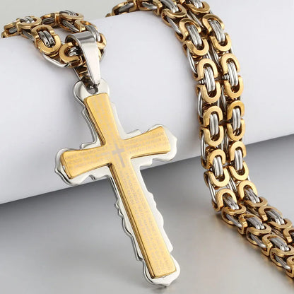 Gold and silver cross and chain displayed on jewelry stand