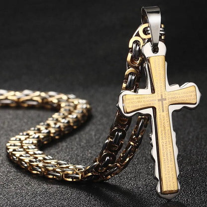 Gold and silver cross standing up on table with chain in back