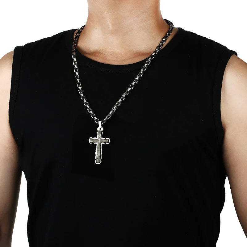Black gold silver cross necklace on mans neck
