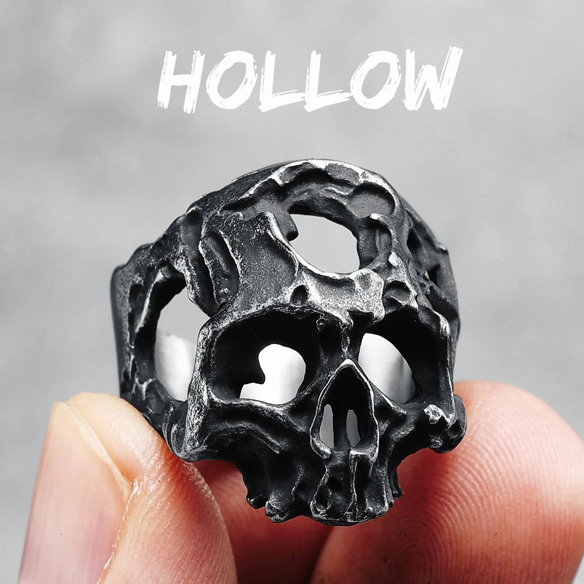 Hollow Skull Ring between two fingers