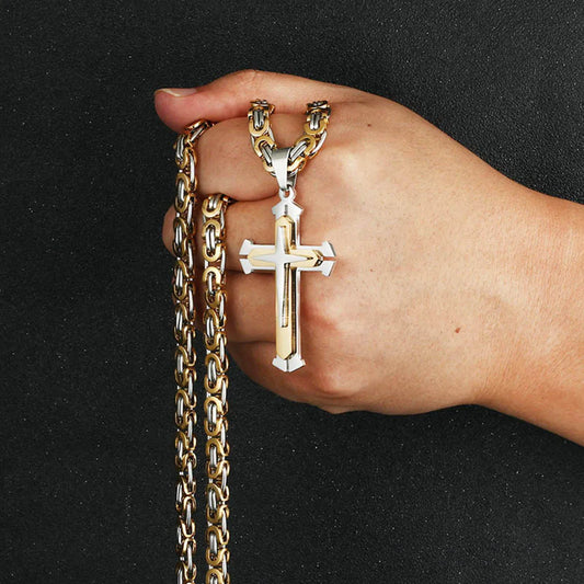 Silver and gold chain held up in hand