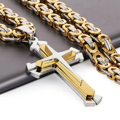 close up of silver and gold cross and chain